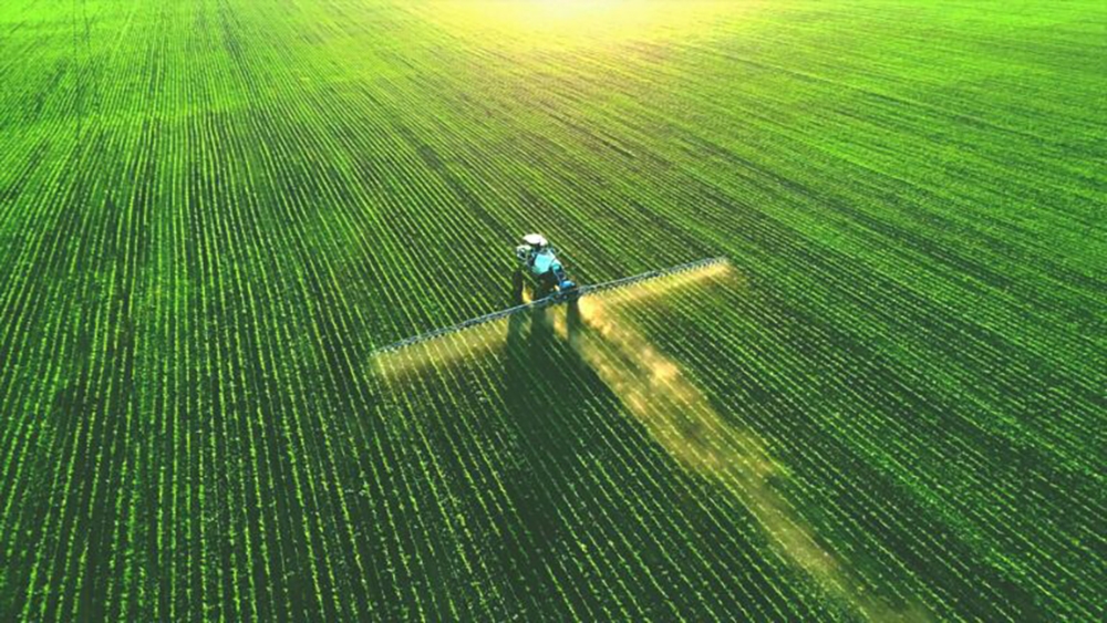 Photo of a tractor applying fertilizer, a product ammonia is used to manufacture